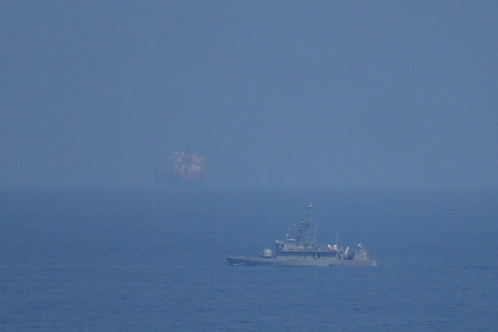 A UAE navy ship patrols the Strait of Hormuz as seen from Mina Al Fajer, United Arab Emirates, Wednesday, March 11, 2026. (AP Photo/Altaf Qadri)