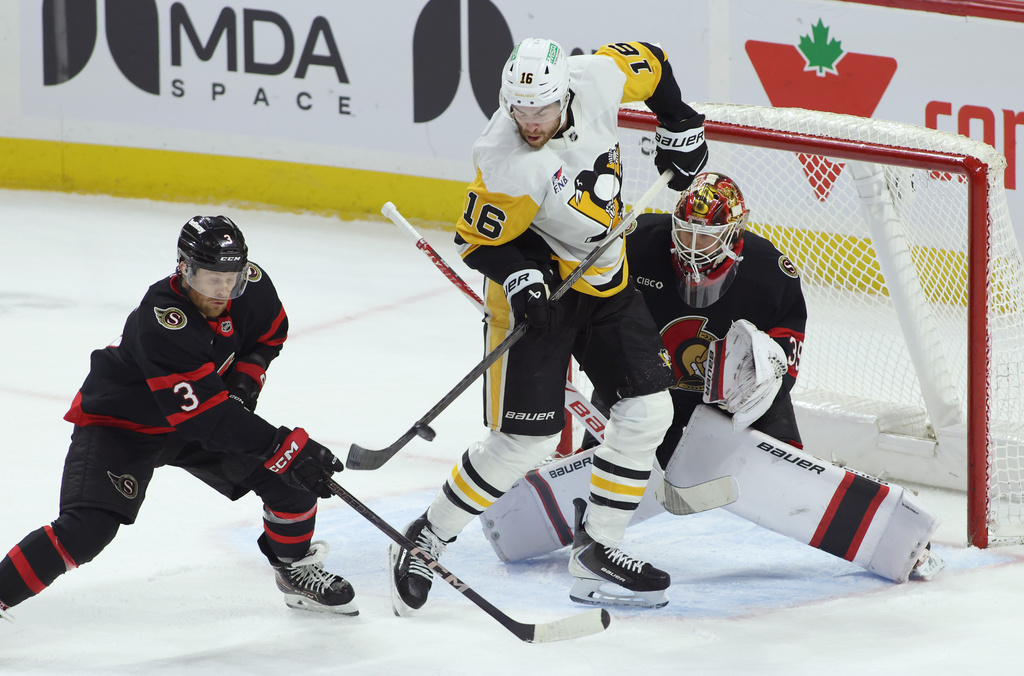 Pittsburgh Penguins' Justin Brazeau (16) tries to tip the puck in front of Ottawa Senators goaltender Linus Ullmark (35) and Nick Jensen (3) during the first period of an NHL hockey game in Ottawa, Ontario, Thursday, Dec. 18, 2025. (Patrick Doyle/The Canadian Press via AP)