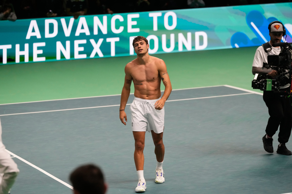 Italy's Flavio Cobolli celebrates after winning against Belgium's Zizou Bergs during a Davis Cup singles semifinal match between Italy and Belgium, in Bologna, Italy, Friday, Nov. 21, 2025. (AP Photo/Luca Bruno)