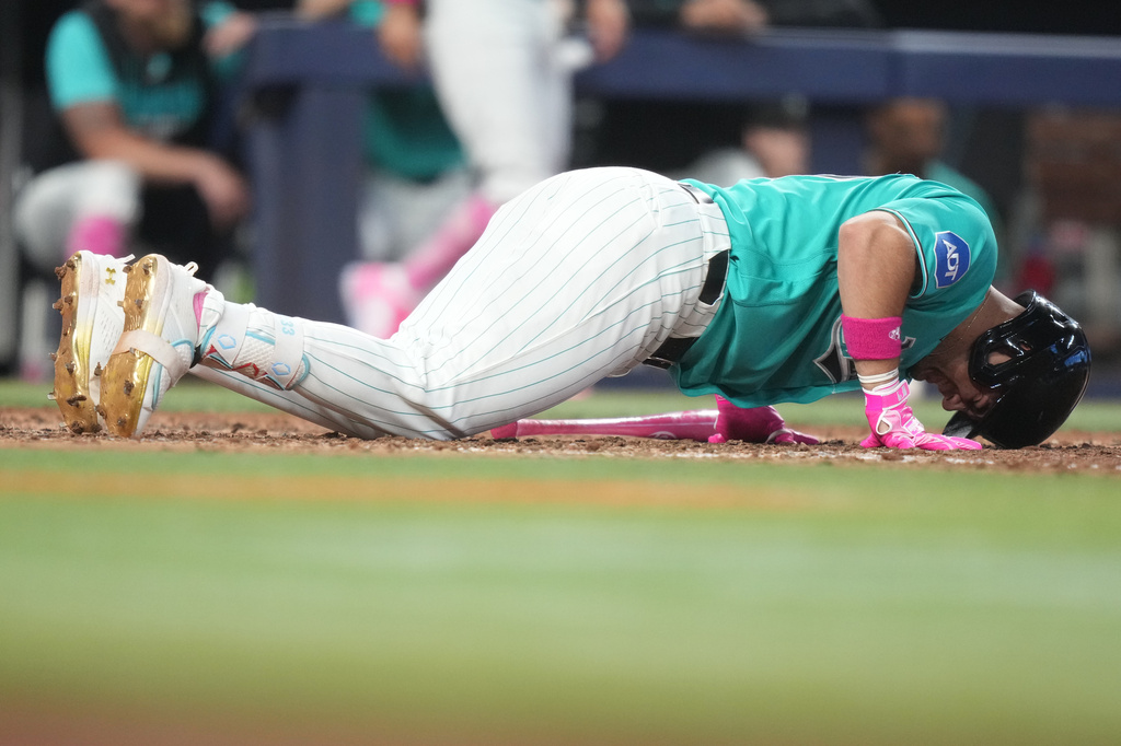 Miami Marlins' Jakob Marsee falls to the field after being hit by a pitch thrown by Washington Nationals starting pitcher Cade Cavalli during the sixth inning of a baseball game, Sunday, May 10, 2026, in Miami. (AP Photo/Lynne Sladky)