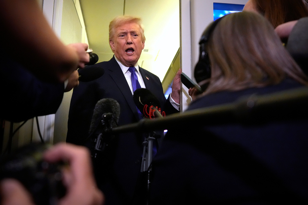 President Donald Trump speaks to reporters as he flies aboard Air Force One from Joint Base Andrews, Md., to West Palm Beach, Fla., Friday, Feb. 6, 2026 (AP Photo/Mark Schiefelbein)
