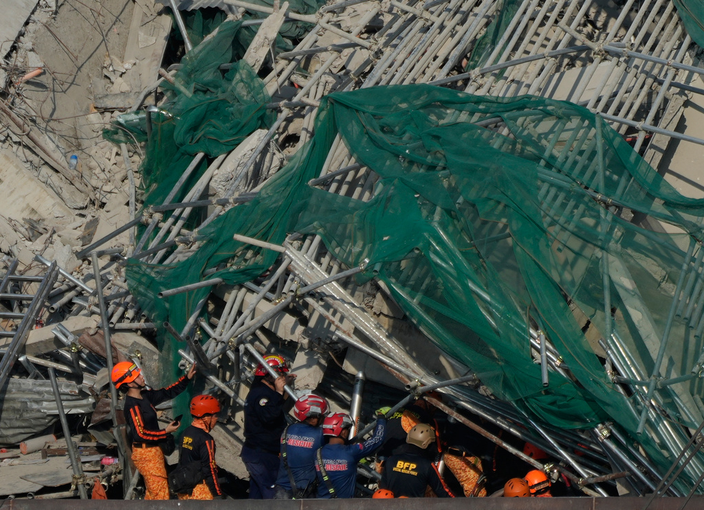 Rescuers continue search operations at a collapsed building where multiple people are believed to be trapped in Angeles city in Pampanga province, north of Manila Monday, May 25, 2026. (AP Photo/Aaron Favila)