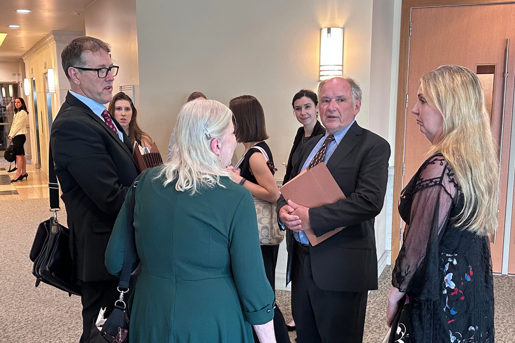 Jim Troupis, former campaign attorney for President Donald Trump, second from right, speaks with a group including his attorney Joe Bugni, left, after pleading not guilty to several felony forgery counts related to the 2020 fake elector scheme Tuesday, June 16, 2026, in Madison, Wis. (AP Photo/Scott Bauer)