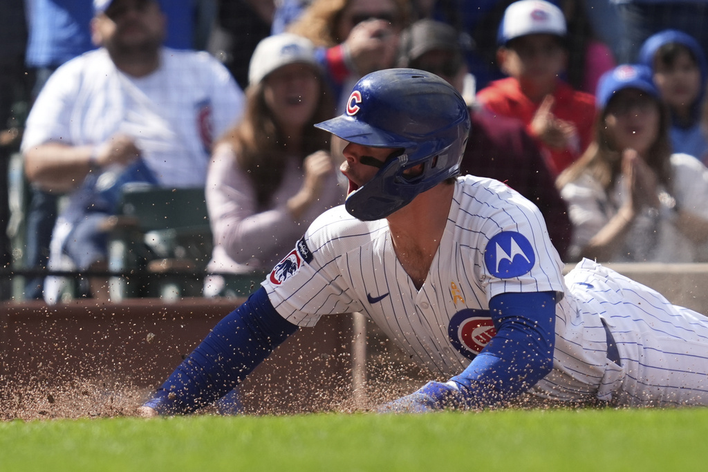Chicago Cubs' Nico Hoerner reacts after scoring on a one-run single by Seiya Suzuki, of Japan, during the fifth inning of a baseball game against the Washington Nationals in Chicago, Sunday, Sept. 7, 2025. (AP Photo/Nam Y. Huh)