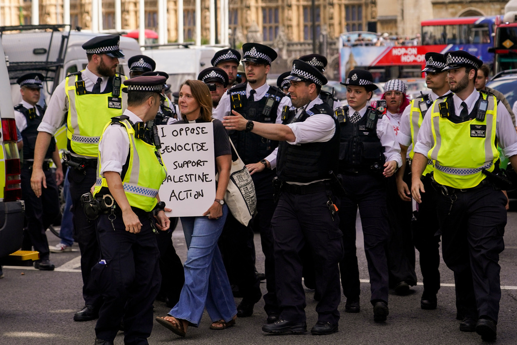 Police officers arrest a demonstrator during a protest in support of the Palestinian people, in Parliament Square, in London, Saturday, Aug. 9, 2025.(AP Photo/Alberto Pezzali)