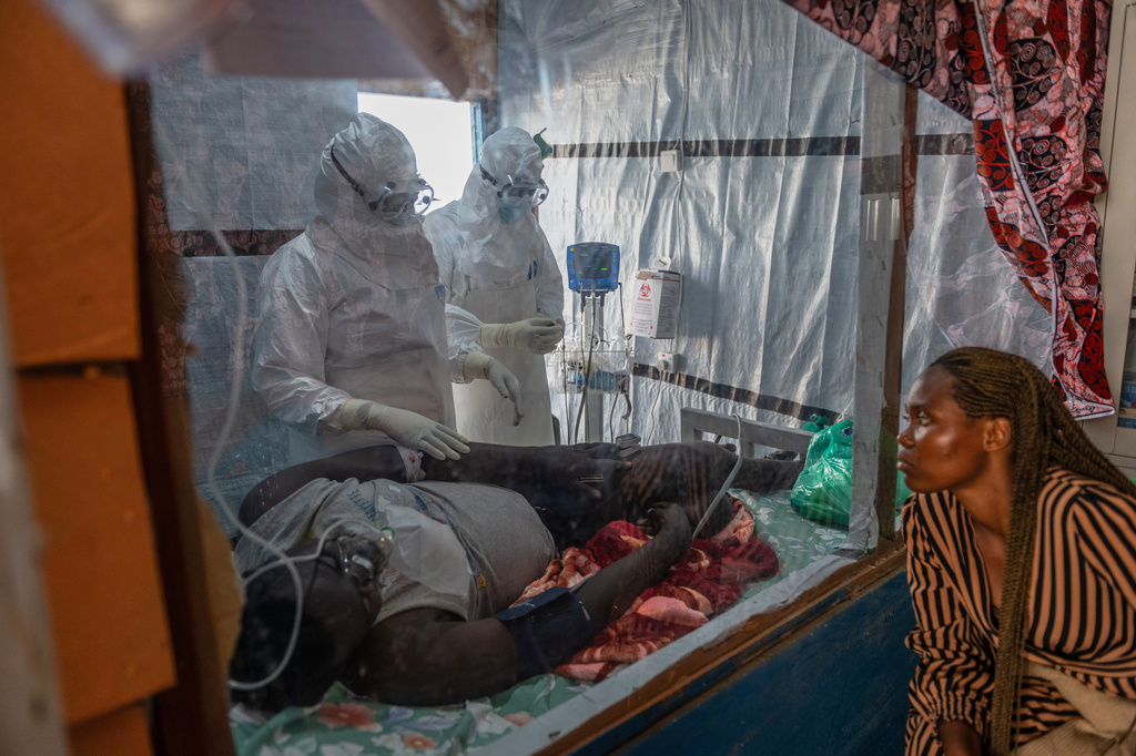 Health workers tend to an Ebola patient at the Rwampara Treatment Center in Ituri, Congo, Thursday, June 18, 2026. (AP Photo/Moses Sawasawa)