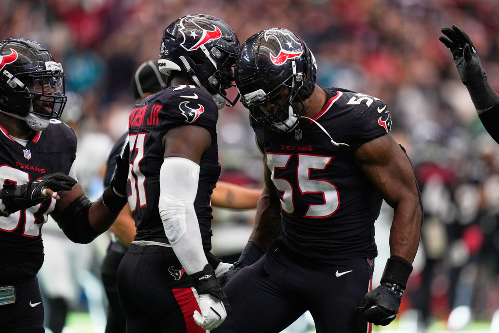 Houston Texans defensive end Danielle Hunter (55) celebrates a sack with teammate Houston Texans defensive end Will Anderson Jr. (51) during the second half of an NFL football game, Sunday, Nov. 9, 2025, in Houston. (AP Photo/Eric Christian Smith)