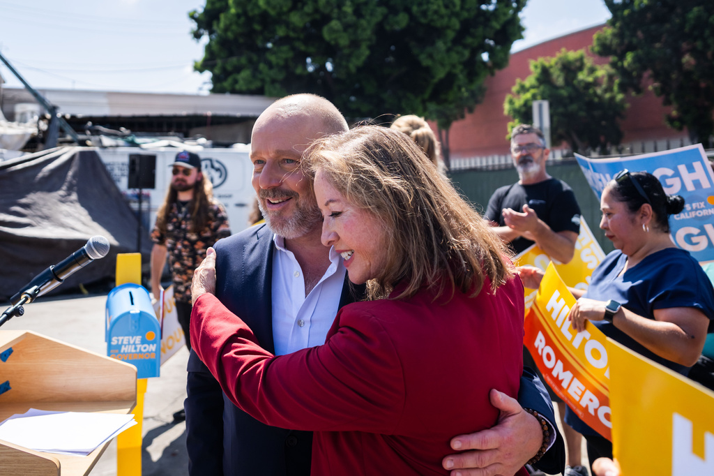 California Lt. Governor candidate Gloria Romero embraces California Republican gubernatorial candidate Steve Hilton, left, during a campaign event on Wednesday, July 22, 2026, in Los Angeles. (AP Photo/Ethan Swope)