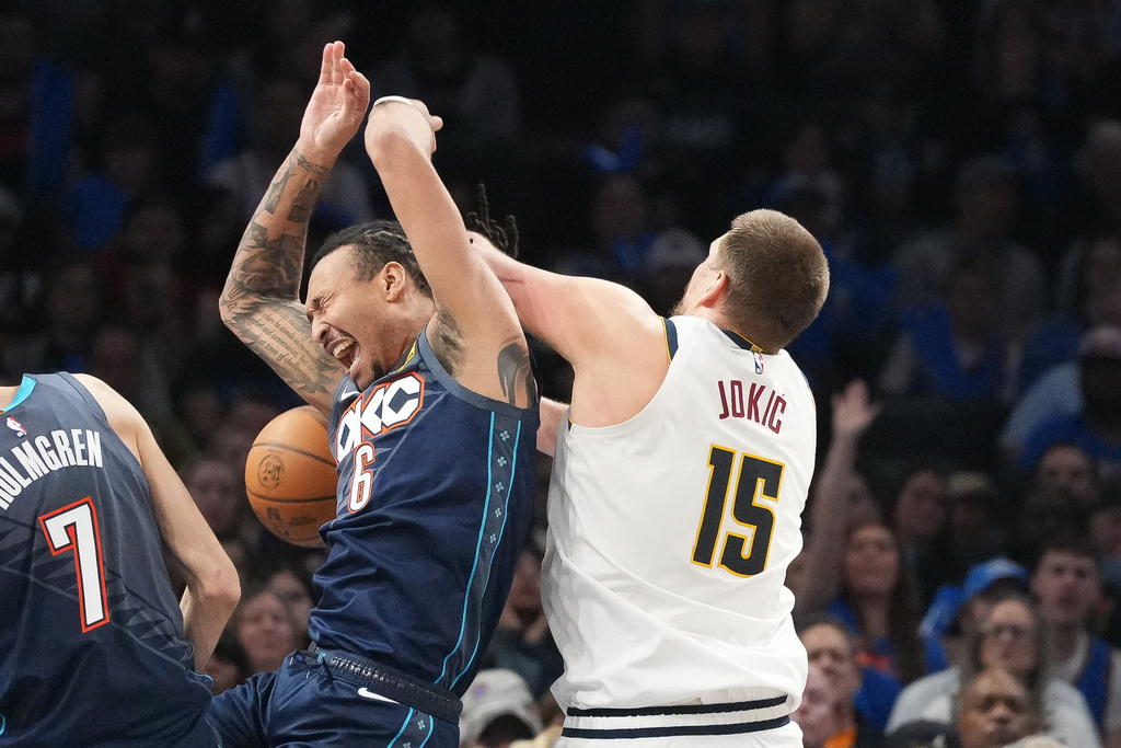 Oklahoma City Thunder forward Jaylin Williams (6) falls into Denver Nuggets center Nikola Jokic (15) as he goes after a rebound during the second half of an NBA basketball game, Friday, Feb. 27, 2026, in Oklahoma City. (AP Photo/Kyle Phillips)
