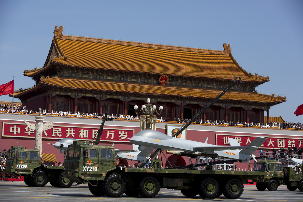 FILE - Military vehicles carrying Wing Loong, a Chinese made medium-altitude long-endurance unmanned aerial vehicle, drive past Tiananmen Gate during a military parade to commemorate the 70th anniversary of Japan's World War II defeat in Beijing, on Sept. 3, 2015. (AP Photo/Andy Wong, Pool, File)