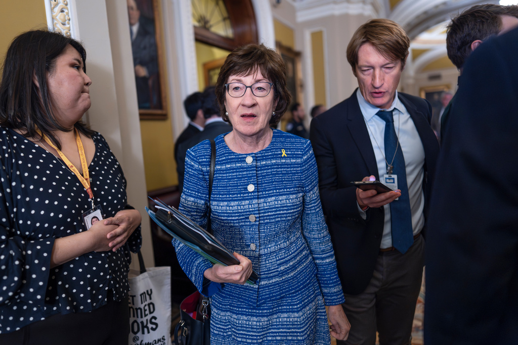As the government shutdown moves into the second week, Senate Appropriations Committee Chairwoman Susan Collins, R-Maine, center, has suggested pushing ahead with a group of bipartisan spending bills that are pending and a then securing a commitment to discuss the health care issue as a way out of the impasse, at the Capitol in Washington, Tuesday, Oct. 7, 2025. (AP Photo/J. Scott Applewhite)
