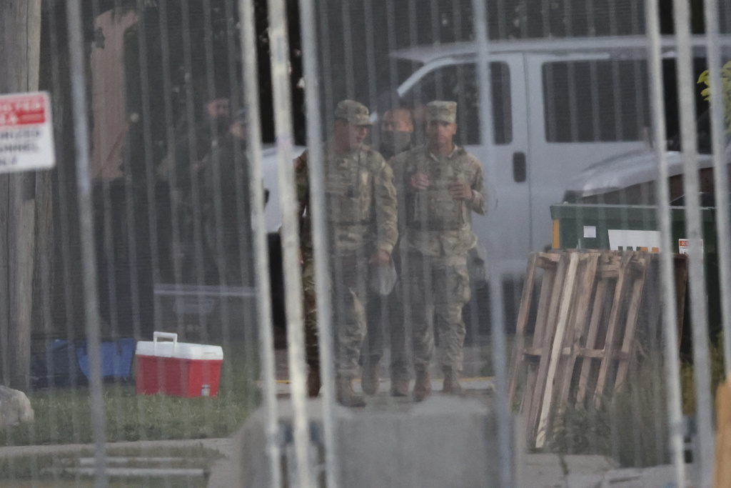 Members of the Texas National Guard stand outside the Immigration and Customs Enforcement (ICE) processing facility in Broadview, Ill., on Thursday, Oct. 9, 2025. (AP Photo/Talia Sprague)