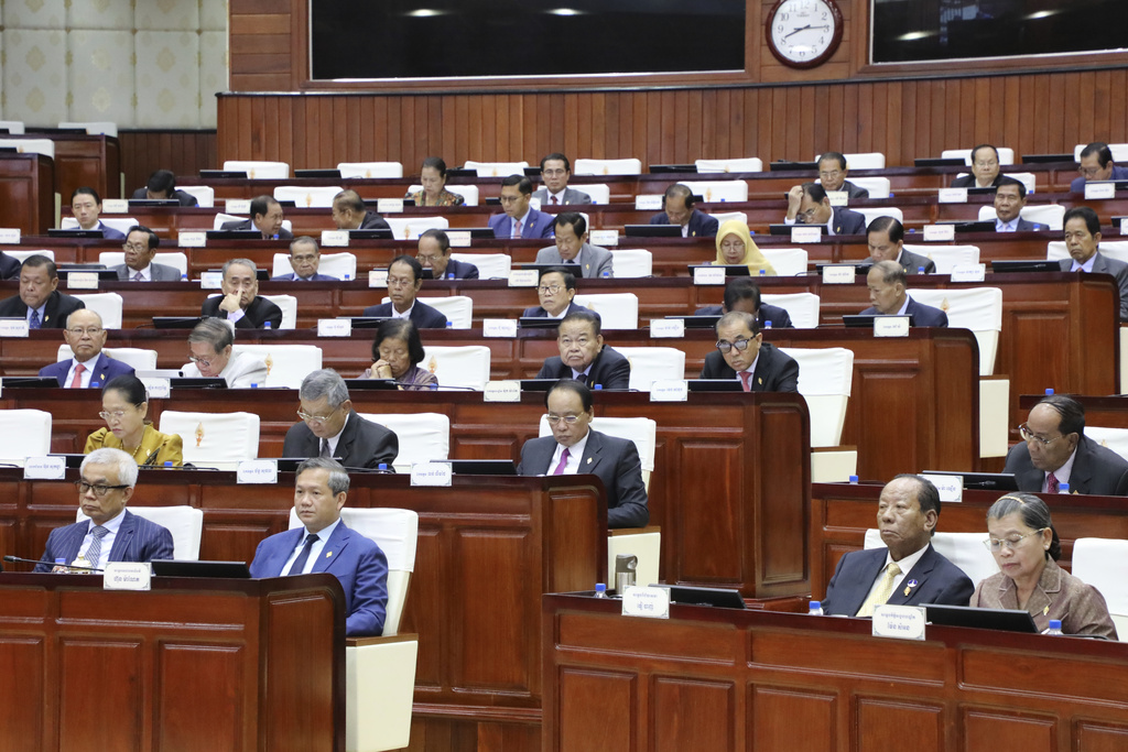 In this photo released by the Cambodia National Assembly, Cambodian Prime Minister Hun Manet, second left, front row, sits together with other lawmakers during the session on the draft law on amending the law on nationality at the National Assembly in Phnom Penh Cambodia, Monday, Aug. 25, 2025. (Cambodia National Assembly via AP)