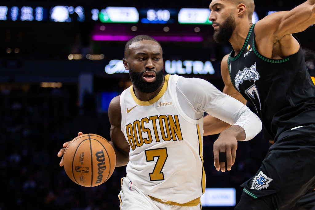 Boston Celtics' Jaylen Brown (7) pushes past Minnesota Timberwolves' Rudy Gobert (27) during the second half of an NBA basketball game, Saturday, Nov. 29, 2025, in Minneapolis. (AP Photo/Lily Dozier)
