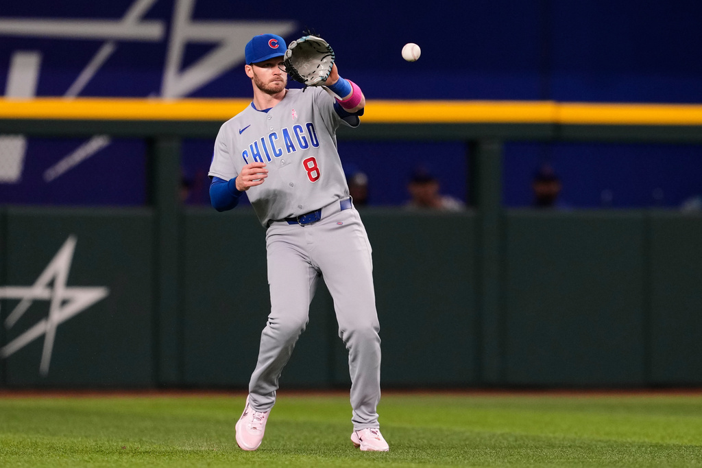 Chicago Cubs' Ian Happ reaches out to glove a single by Texas Rangers' Josh Jung in the fourth inning of a baseball game Sunday May 10, 2026, in Arlington, Texas. (AP Photo/Tony Gutierrez)