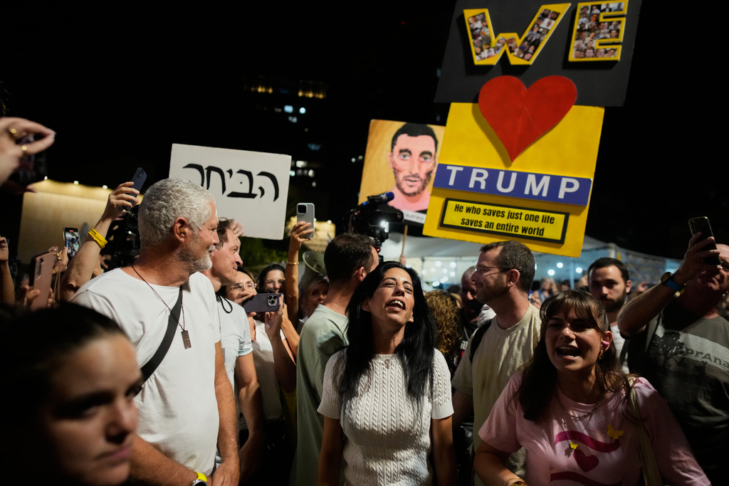 Einav Zangauker, center, mother of Matan Zangauker, who is being held hostage by Hamas, reacts as she and others celebrate following the announcement that Israel and Hamas have agreed to the first phase of a peace plan to pause the fighting, at a plaza known as Hostages Square in Tel Aviv, Israel, Thursday, Oct. 9, 2025. (AP Photo/Ohad Zwigenberg)
