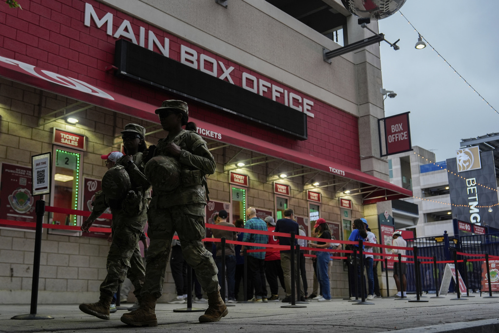 Members of the District Of Columbia National Guard patrol in front of Nationals Park, Tuesday, Aug. 19, 2025, in the Navy Yard neighborhood of Washington. (AP Photo/Julia Demaree Nikhinson)