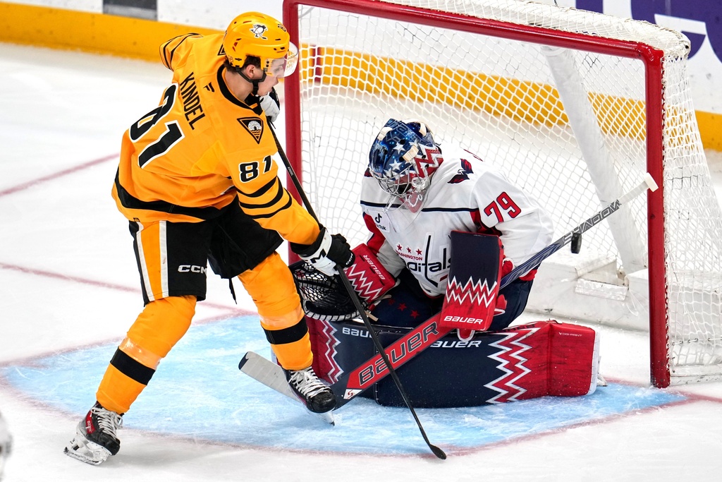 Washington Capitals goaltender Charlie Lindgren (79) blocks a shot by Pittsburgh Penguins' Ben Kindel (81) during the first period of an NHL hockey game in Pittsburgh, Thursday, Nov. 6, 2025. (AP Photo/Gene J. Puskar)