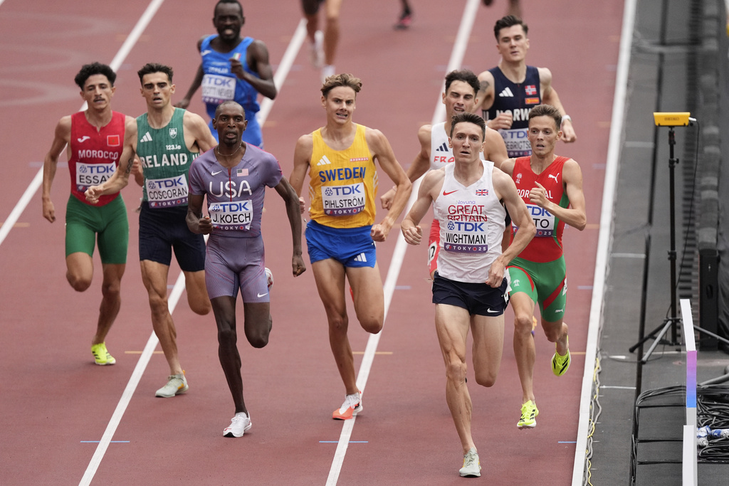 Britain's Jake Wightman, second right, competes in a men's 1,500 meters heat as Norway’s Jakob Ingebrigtsen, rear right, finishes in 8th at the World Athletics Championships in Tokyo, Sunday, Sept. 14, 2025. (AP Photo/Abbie Parr)