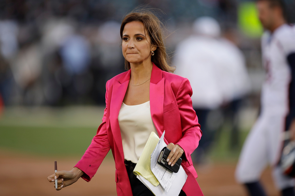 FILE - ESPN reporter Dianna Russini stands on the sidelines before the start of an NFL football game between the Oakland Raiders and the Denver Broncos on Sept. 9, 2019, in Oakland, Calif. (AP Photo/Ben Margot, File)