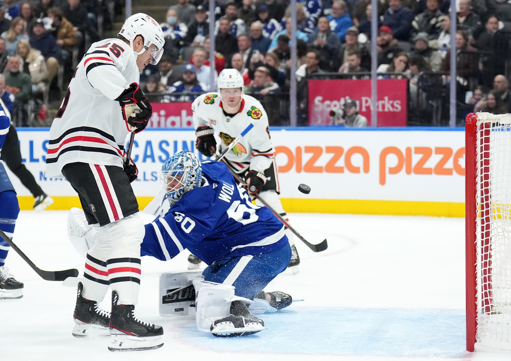 Chicago Blackhawks forward Dominic Toninato (25) scores past Toronto Maple Leafs goaltender Joseph Woll (60) during first period NHL hockey action in Toronto, Tuesday, Dec. 16, 2025. (Nathan Denette/The Canadian Press via AP)