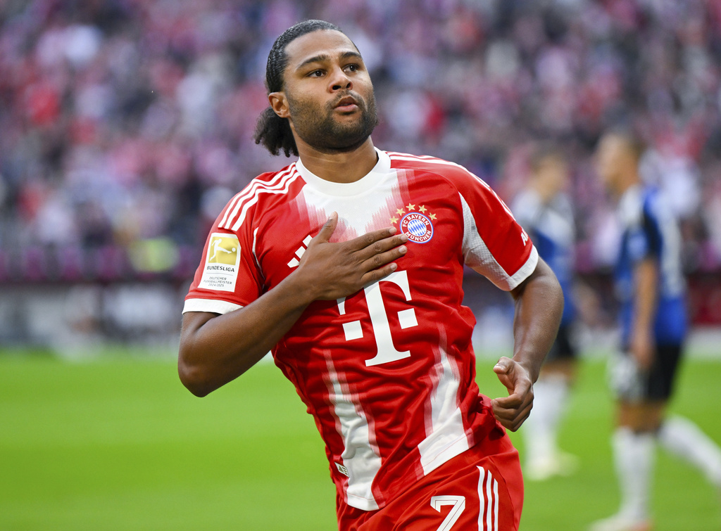 Munich's Serge Gnabry celebrates after scoring the opening goal during the German Bundesliga soccer match between FC Bayern Munich and Hamburger SV in Munich, Germany, Saturday, Sept. 13, 2025. (Sven Hoppe/dpa via AP)