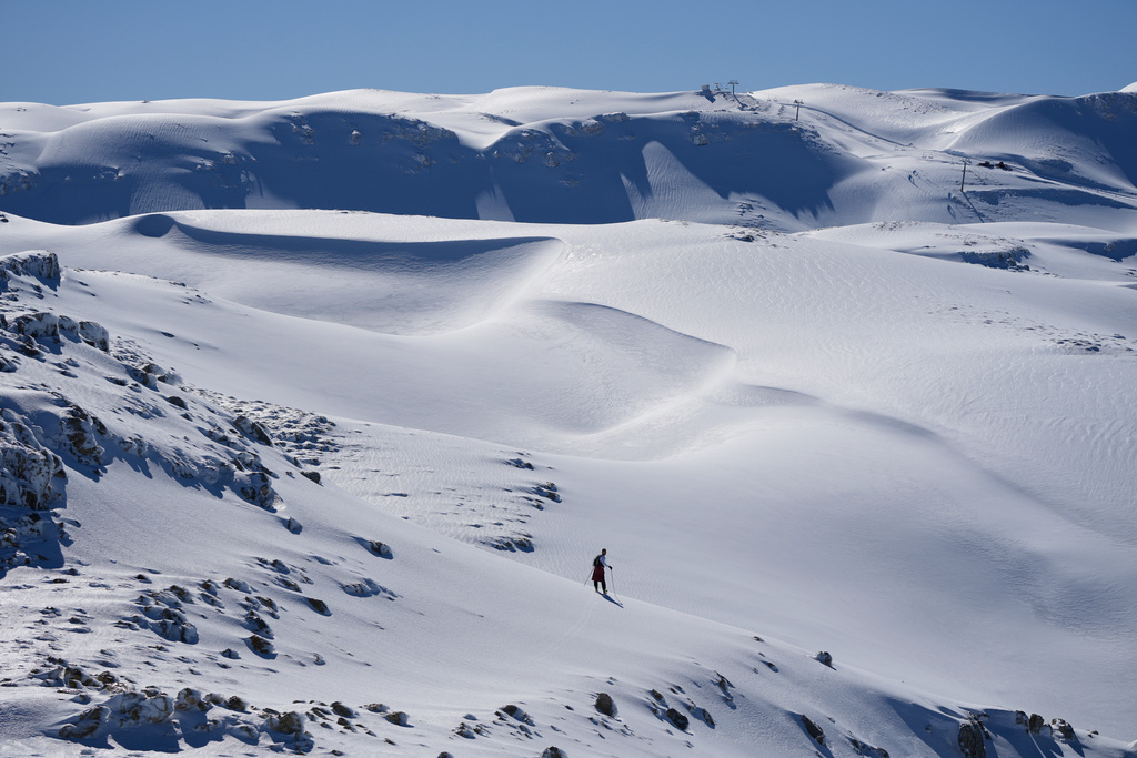 A lone skier crosses a snow-covered slope at the Mzaar-Kfardebian ski resort northeast of Beirut, Lebanon, Saturday, Jan. 3, 2026. (AP Photo/Hassan Ammar)