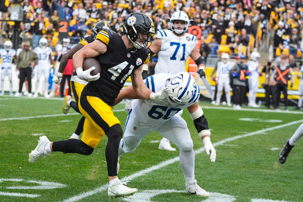 Pittsburgh Steelers linebacker Payton Wilson (41) runs past Indianapolis Colts center Tanor Bortolini (60) after an interception during the first half of an NFL football game in Pittsburgh, Sunday, Nov. 2, 2025. (AP Photo/Gene J. Puskar)