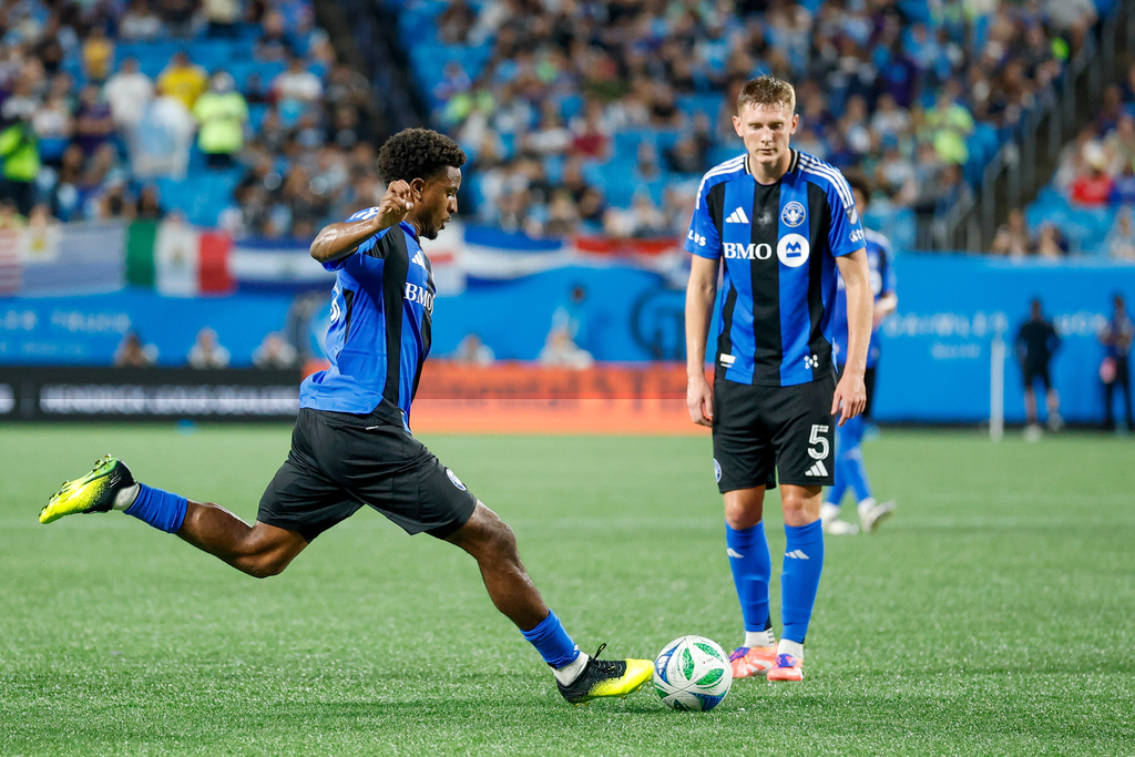 CF Montreal forward Dante Sealy, left, scores on a free kick against Charlotte FC as defender Brandan Craig (5) looks on during the first half of an MLS soccer match in Charlotte, N.C., Saturday, Sept. 27, 2025. (AP Photo/Nell Redmond)