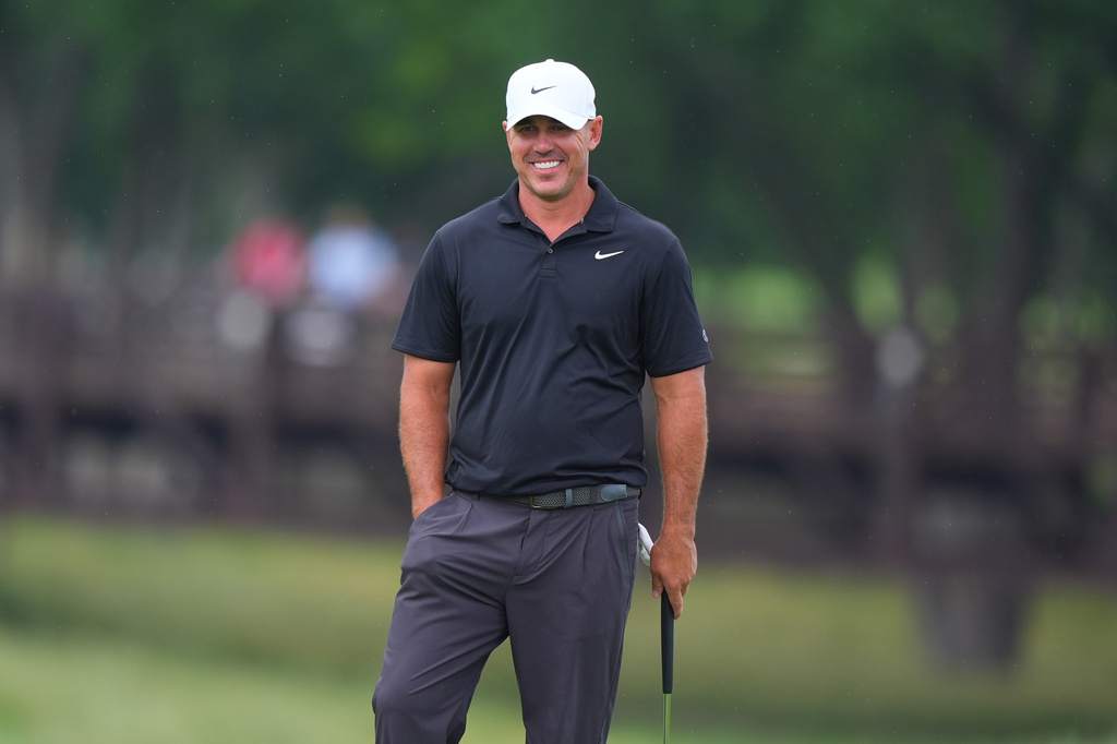 Brooks Koepka smiles while standing on the ninth green during of the first round of the Byron Nelson golf tournament in McKinney, Texas, Thursday, May 21, 2026. (AP Photo/LM Otero)