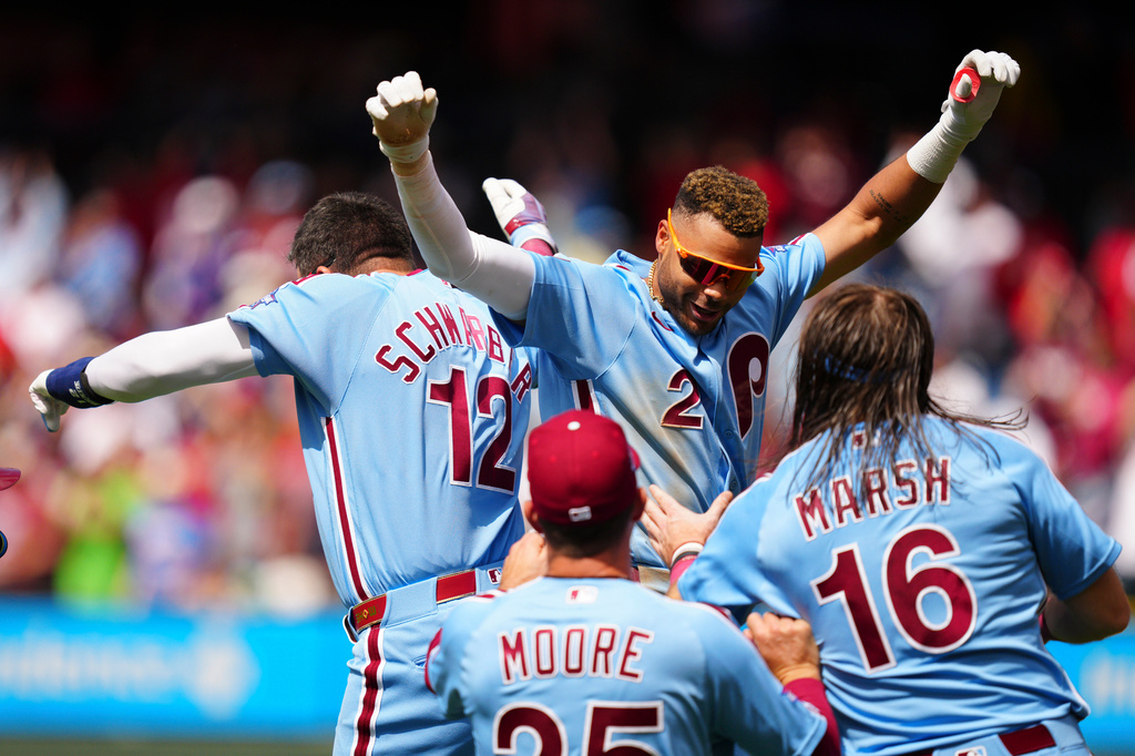 Philadelphia Phillies' Justin Crawford (2) celebrates his walk-off RBI single with Kyle Schwarber (12) after the first baseball game of a doubleheader against the San Francisco Giants, Thursday, April 30, 2026, in Philadelphia. (AP Photo/Derik Hamilton)