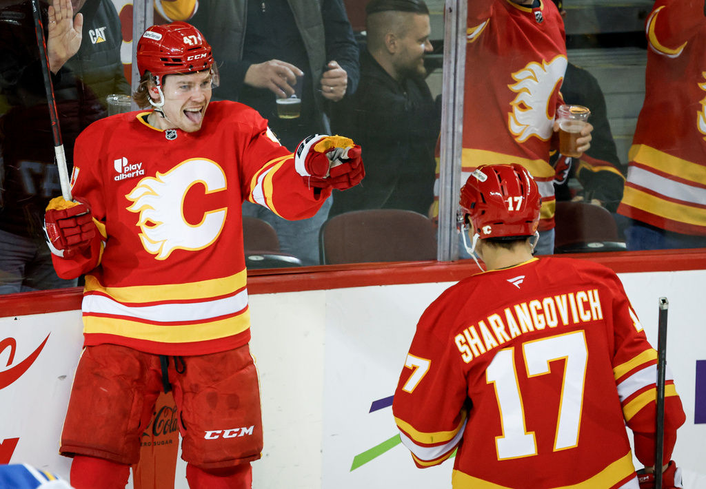 Calgary Flames' Connor Zary, left, celebrates his goal with teammate Yegor Sharangovich during the first period of an NHL hockey game in Calgary on Wednesday, March 18, 2026. (Jeff McIntosh/The Canadian Press via AP)
