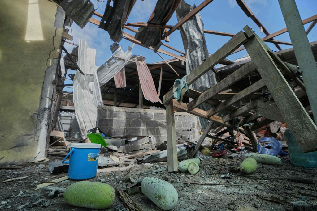 This shows a house which, Thai local security forces say, was damaged by a Cambodian artillery strike in Surin province, Thailand, Thursday, Dec. 11, 2025. (AP Photo/Sakchai Lalit)