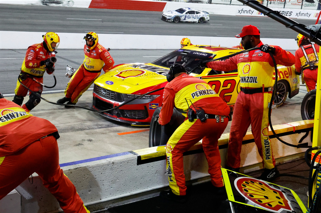 Crew members perform a pit stop on driver Joey Logano's car during a NASCAR Cup Series auto race in North Wilkesboro, N.C., Sunday, July 19, 2026. (AP Photo/Terry Renna)