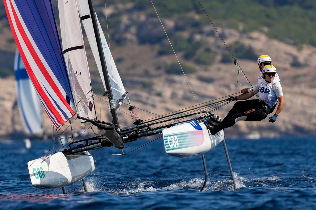 FILE - Anna Burnet and John Gimson, of Britain, compete in the Nacra 17 mixed multihull sailing race during the 2024 Summer Olympics, Aug. 6, 2024, in Marseille, France. (AP Photo/Carolyn Kaster, File)