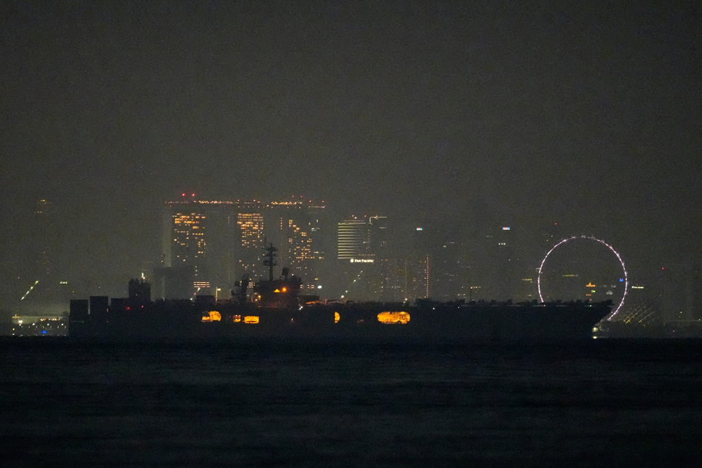 The U.S. Navy aircraft carrier USS Abraham Lincoln sails past Singapore as seen from Batam, Indonesia, Sunday, Aug. 30, 2026. (AP Photo/Dita Alangkara)