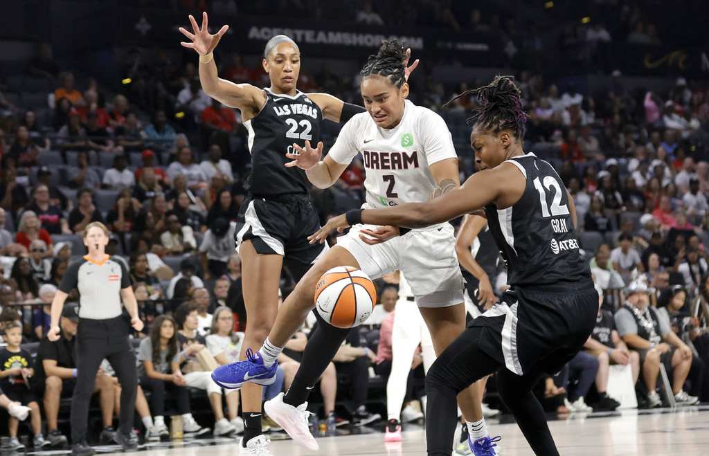 Atlanta Dream guard Te-Hina Paopao (2) loses control of the ball after being fouled by Las Vegas Aces guard Chelsea Gray (12) during the first half of a WNBA basketball game, Tuesday, Aug. 19, 2025, in Las Vegas. (Steve Marcus/Las Vegas Sun via AP)
