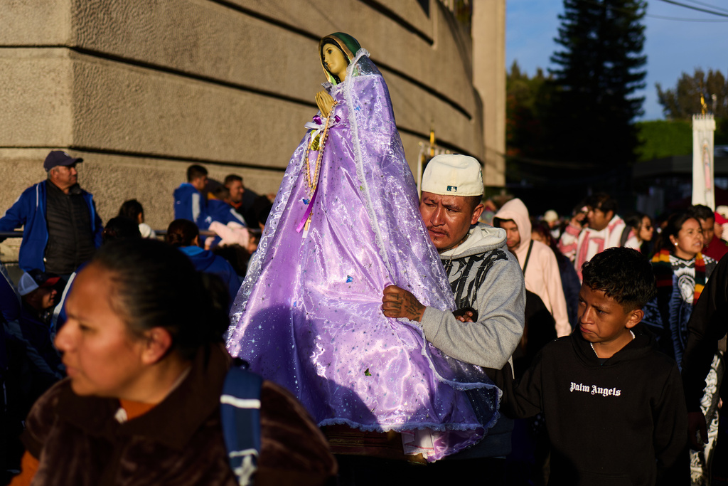 Pilgrims arrive to Our Lady of Guadalupe Basilica in Mexico City, Thursday, Dec. 11, 2025, the day before her feast day. (AP Photo/Claudia Rosel)