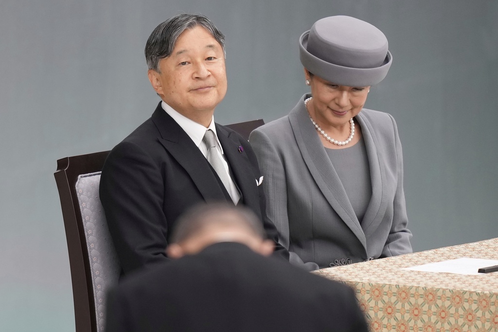 Japan's Prime Minister Shigeru Ishiba, bottom, bows to Emperor Naruhito and Empress Masako as they attend a memorial service marking the 80th anniversary of Japan's World War II defeat, at the Nippon Budokan hall Friday, Aug. 15, 2025, in Tokyo. (AP Photo/Eugene Hoshiko)
