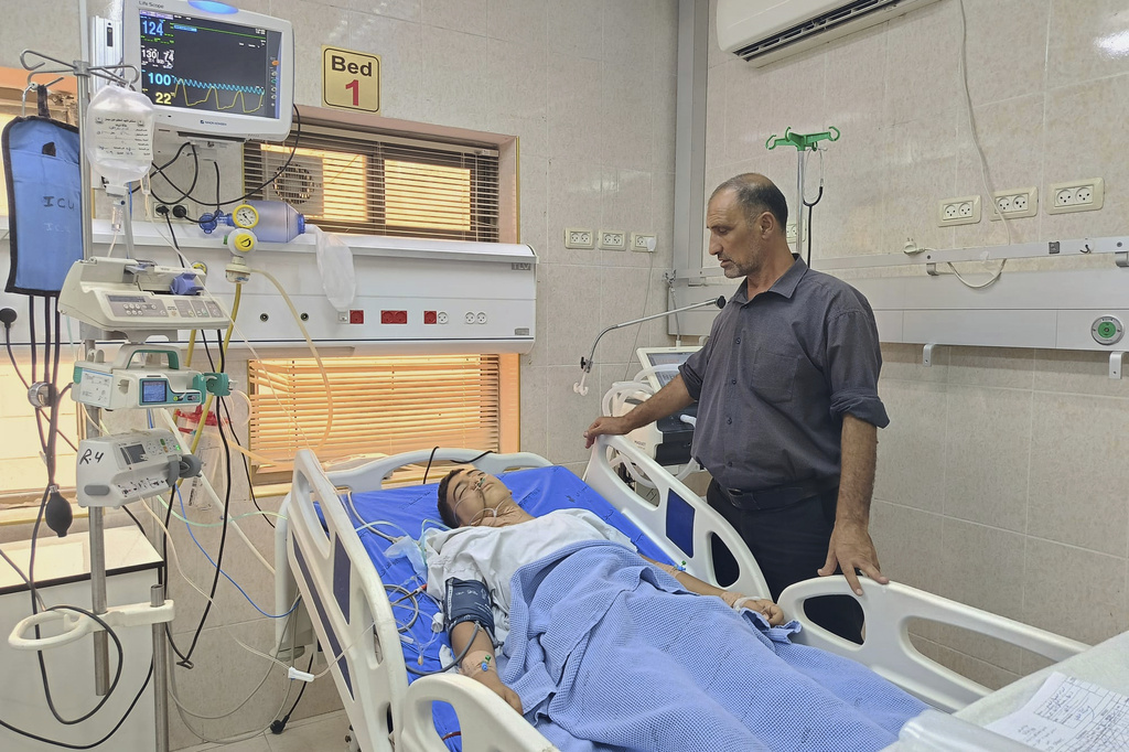 Faisal Nasrallah visits his 14-year-old son, Oday Nasrallah, at a hospital in the West Bank city of Jenin Thursday, Sept. 11, 2025. According to the Palestinian Red Crescent and the hospital's director, Oday was shot by Israeli troops in the West Bank the previous day. (AP Photo/Aref Tuffaha)