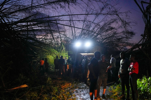 Workers clear downed trees and debris to make way for a convoy carrying aid to Black River, which was hit by Hurricane Melissa, as it moves through Holland Bamboo, Jamaica, Wednesday, Oct. 29, 2025. (AP Photo/Matias Delacroix) Workers clear downed trees and debris to make way for a convoy carrying aid to Black River, which was hit by Hurricane Melissa, as it moves through Holland Bamboo, Jamaica, Wednesday, Oct. 29, 2025. (AP Photo/Matias Delacroix)