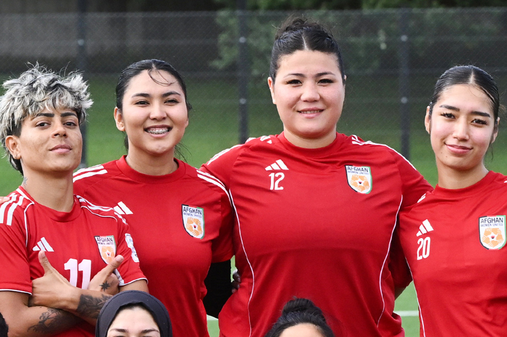 Afghan women's player Fatima Yousufi, second right, stands with teammates in a team photo following a training session in Auckland, New Zealand, Tuesday, June 2, 2026. (Andrew Cornaga/Photosport via AP)