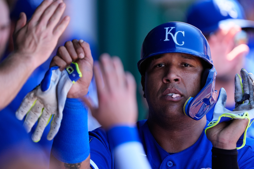 Kansas City Royals' Salvador Perez celebrates in the dugout after scoring on a sacrifice fly hit by Michael Massey during the second inning of baseball game against the New York Yankees, Monday, May 25, 2026, in Kansas City, Mo. (AP Photo/Charlie Riedel)