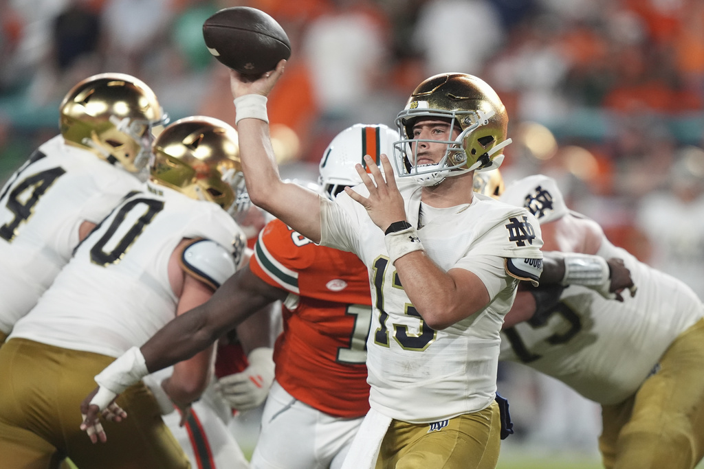 Notre Dame quarterback CJ Carr (13) throws during the second half of an NCAA college football game against Miami, Sunday, Aug. 31, 2025, in Miami Gardens, Fla. (AP Photo/Lynne Sladky)