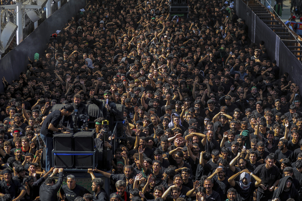 Shiite pilgrims participate in Arbaeen, which marks the end of the 40-day mourning period following Ashoura, in Karbala, Iraq, Thursday, Aug. 14, 2025. (AP Photo/Ammar Khalil)