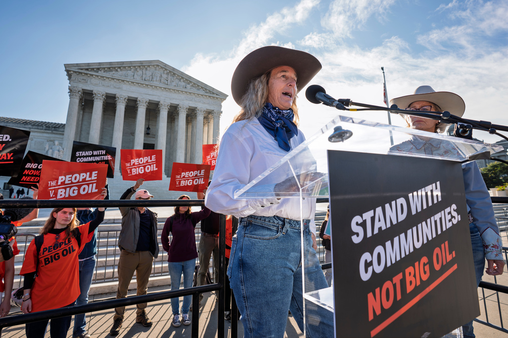 Colorado rancher Kathryn Bedell talks about the impact of droughts on her business as activists gather at the Supreme Court for a case about whether oil and gas companies should help pay for damage caused by disasters linked to climate change, on Capitol Hill in Washington, Monday, Oct. 5, 2026. (AP Photo/J. Scott Applewhite)