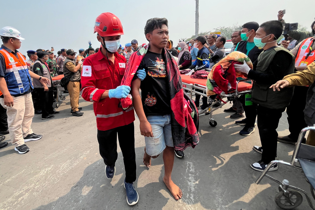 In this photo taken with a smartphone, survivors from a passenger ferry overturned in bad weather in the Java Sea arrive at a port in Banjarmasin, South Kalimantan, Indonesia, Tuesday, Sept. 15, 2026. (AP Photo/Iman Satria)