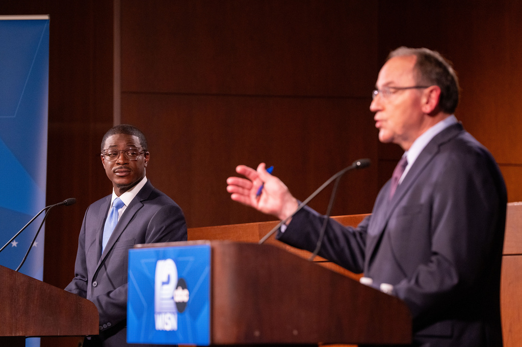 Wisconsin Democratic gubernatorial nominee David Crowley, left, listens as Wisconsin Republican gubernatorial nominee Tom Tiffany speaks during a debate at Marquette University Law School, Wednesday, Oct. 21, 2026, in Milwaukee. (AP Photo/Lizzy Larson)