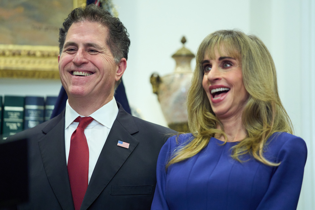 Michael Dell, and his wife Susan, laugh as President Donald Trump speaks during an event on "Trump Accounts" for kids in the Roosevelt Room of the White House, Tuesday, Dec. 2, 2025, in Washington. (AP Photo/Evan Vucci)
