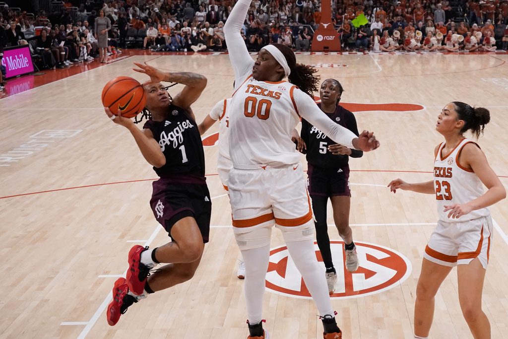 Texas A&M guard Ny'ceara Pryor drives to the basket against Texas center Kyla Oldacre (00) during the first half of an NCAA college basketball game in Austin, Texas, Sunday, Jan. 18, 2026. (AP Photo/Eric Gay)